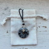 Larvakite donut pendant wrapped with sterling silver swizzel on adjustable black cord
